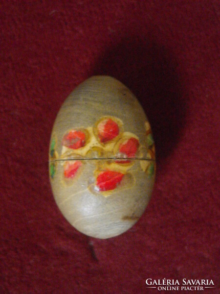 Handmade miniature doll in a wooden egg