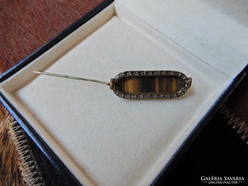Old copper brooch with tiger's eye stone