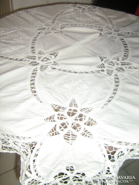 Beautiful ribbon embroidered on white lace tablecloth