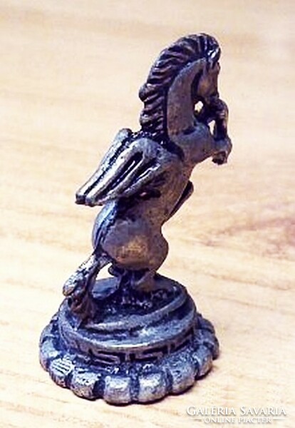 Antique miniature lead figure. A stallion with a crown