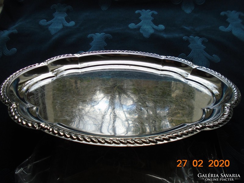 Chrome-nickel metal tray with a baroque shape, embossed rim, and chiseled antique patterns