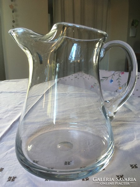 A large glass jug with a special shape