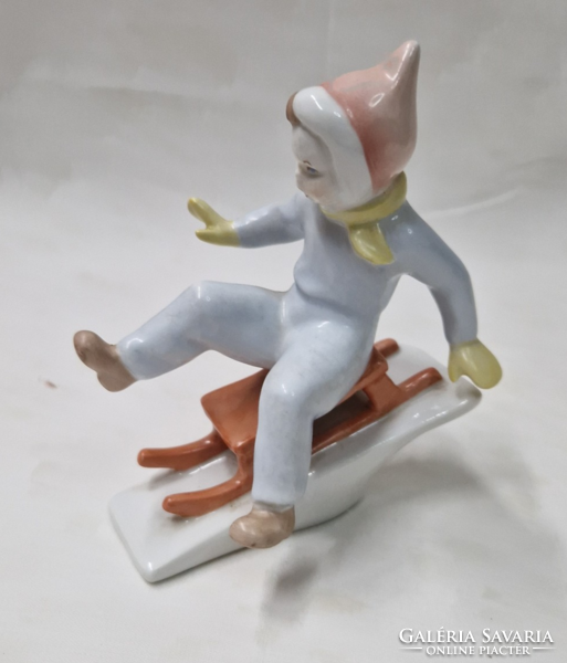 Aquincumi porcelán szánkózó fiú figura hibátlan állapotban 11 cm.