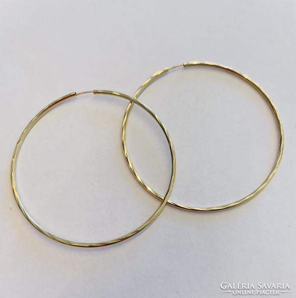 Large hoop earrings in yellow gold