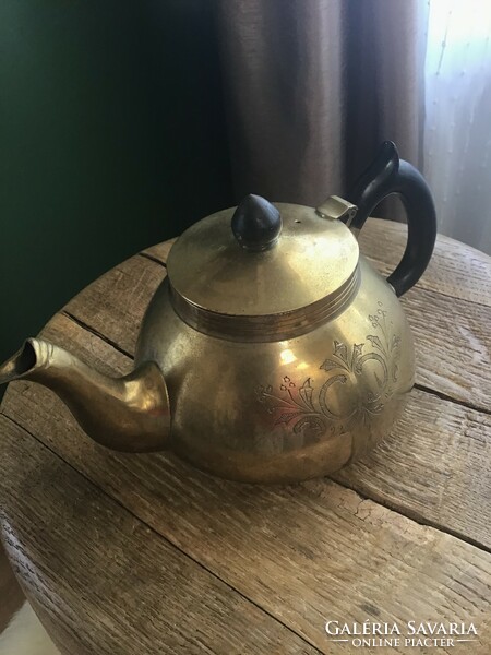 Old copper tea pourer with hand-engraved pattern