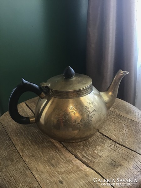 Old copper tea pourer with hand-engraved pattern