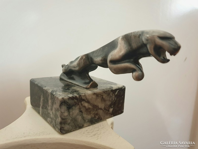 Jaguar logo metal statue on a marble plinth