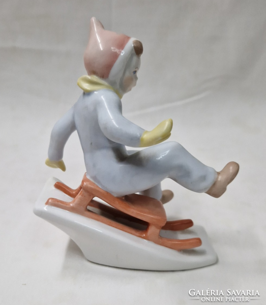 Aquincum porcelain sledding boy figure in perfect condition 11 cm.