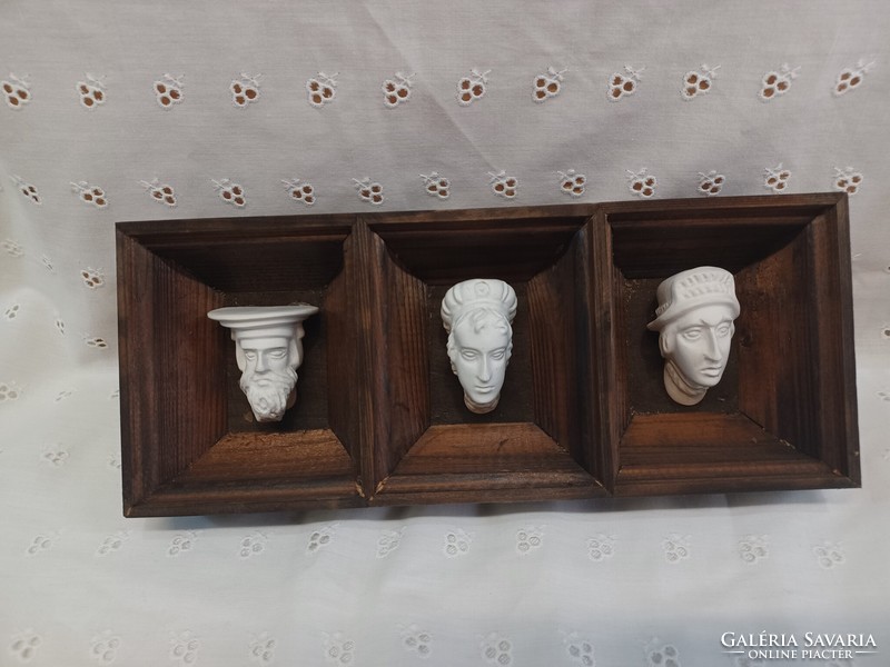 Old plaster heads, in a wooden frame. The Krakow Wawel