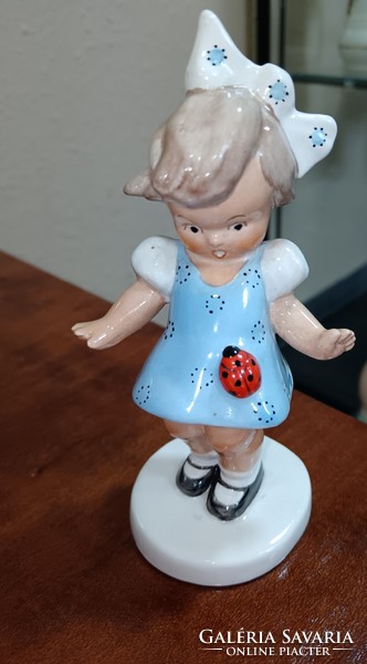 Bodrogkeresztúr little girl in a blue dress with a ladybug