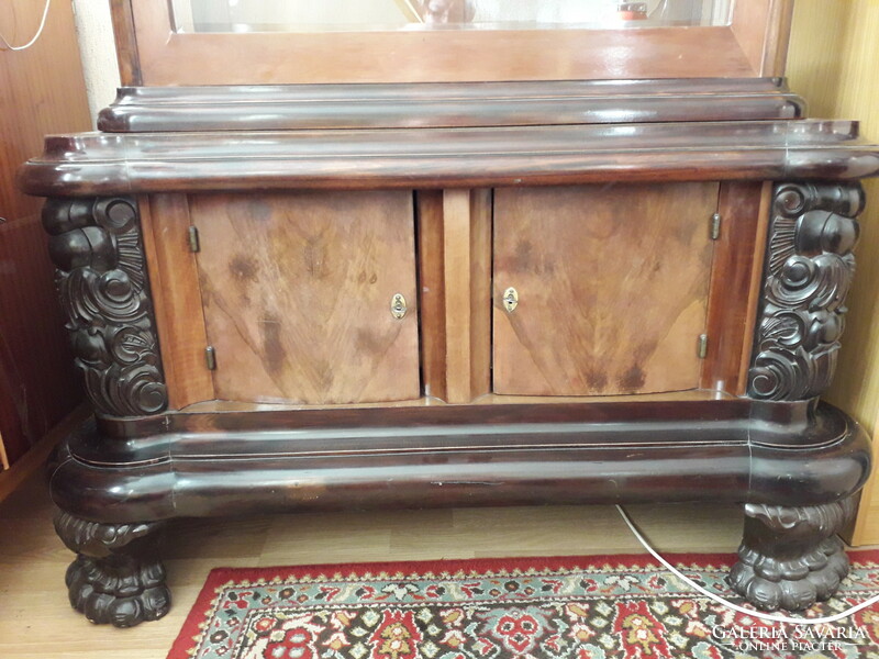 Eclectic display case decorated with carvings from the beginning of the last century