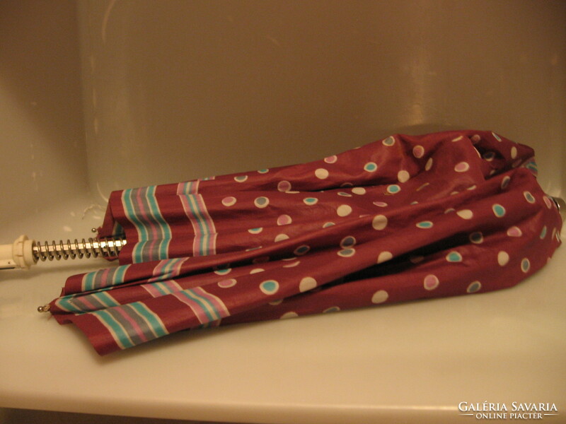 Retro polka dot-striped umbrella for repair