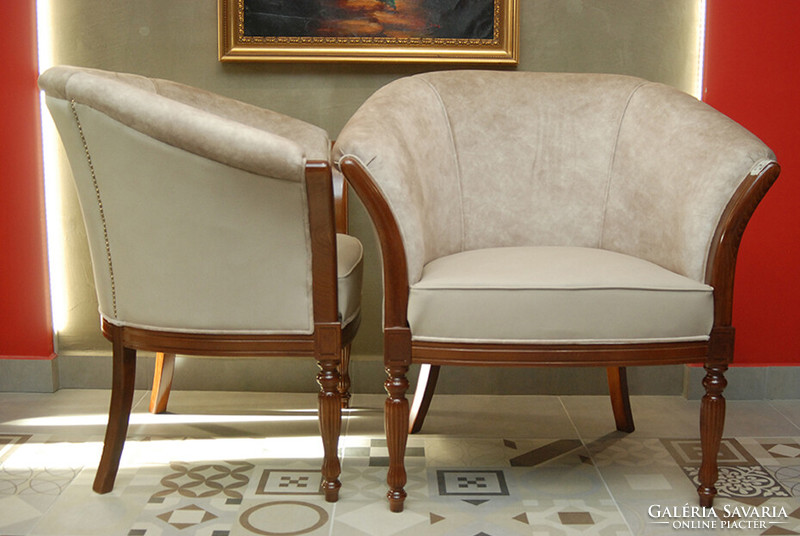 A pair of armchairs with art deco characters