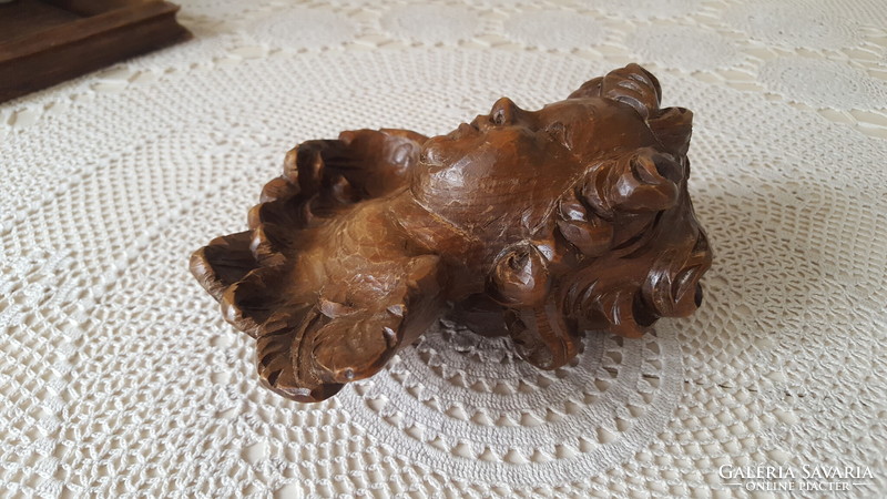 Beautiful angel head carved from old wood