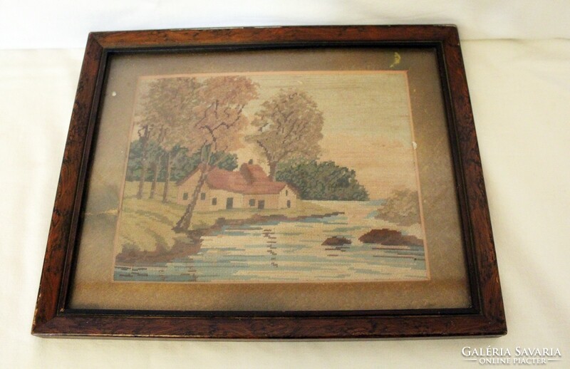 Old tapestry in a wooden frame