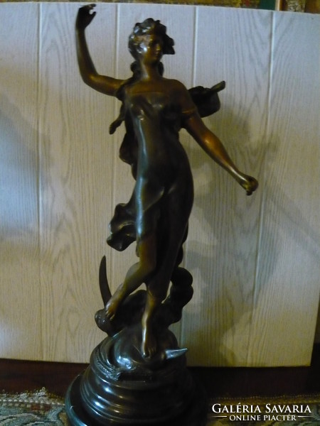 Beautiful bronze statue on a marble plinth