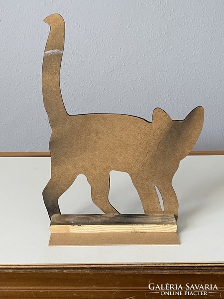 A cozy silhouette sculpture of a black cat cat made of wood