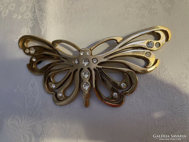 Large metal butterfly decorated with stones.