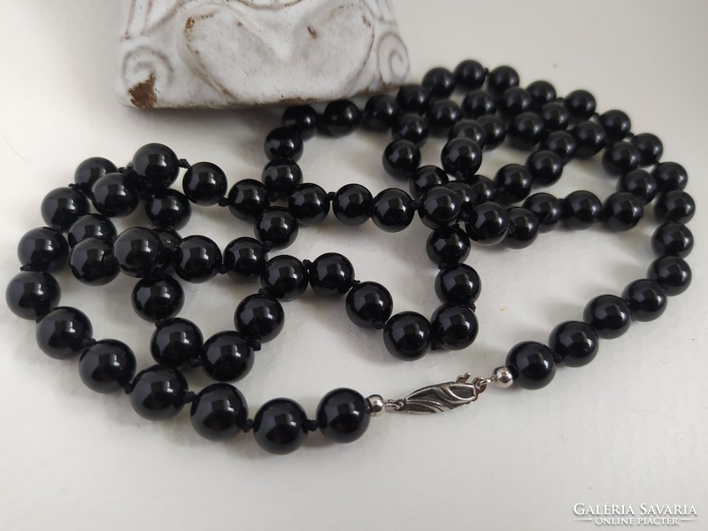 Long onyx necklace knotted with a silver clasp