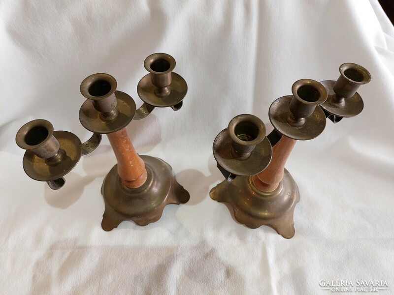 2 identical three-pronged candle holders with wooden bodies