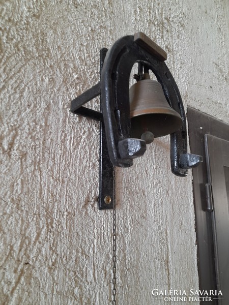 Antique copper gate bell with wrought iron horseshoe