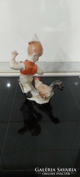 Porcelain figurine of a boy with a rooster from Herend