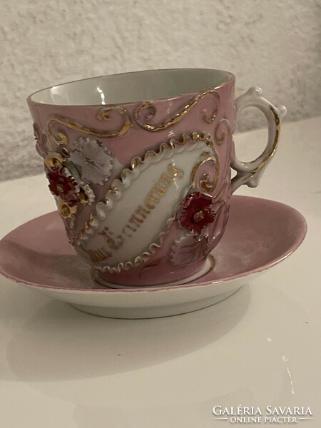 Antique embossed porcelain mug with small plate.