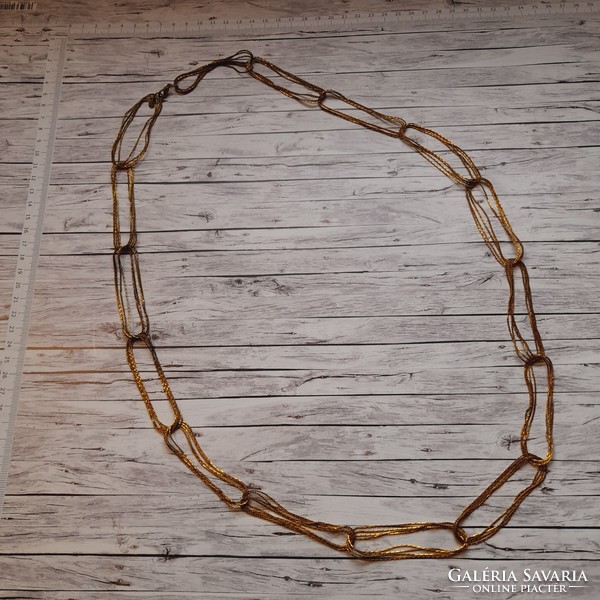 Gold-colored, long bijou necklace