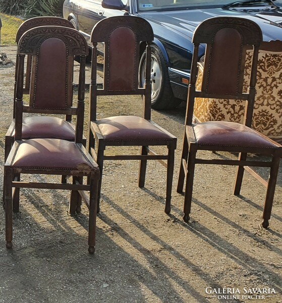 Antique, riveted, carved leather chairs.