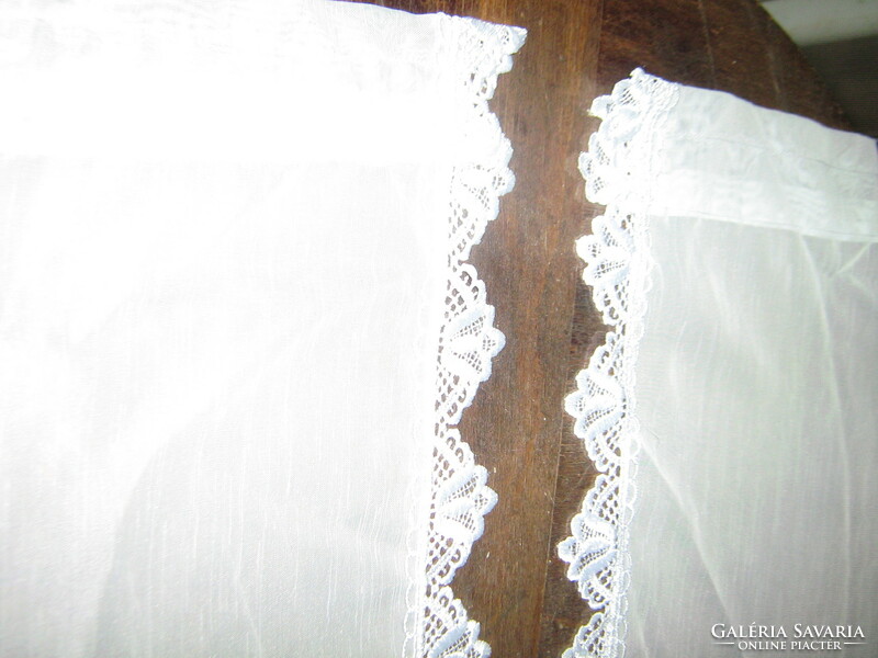 A pair of beautiful vintage style stained glass curtains with a lace edge