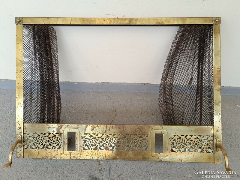 Antique brass stove embers in front of fireplace with retractable braid net 613 8587