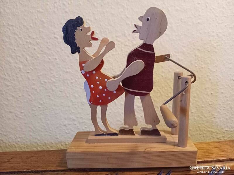 Old, retro wooden toy, kissing couple with rolling arms