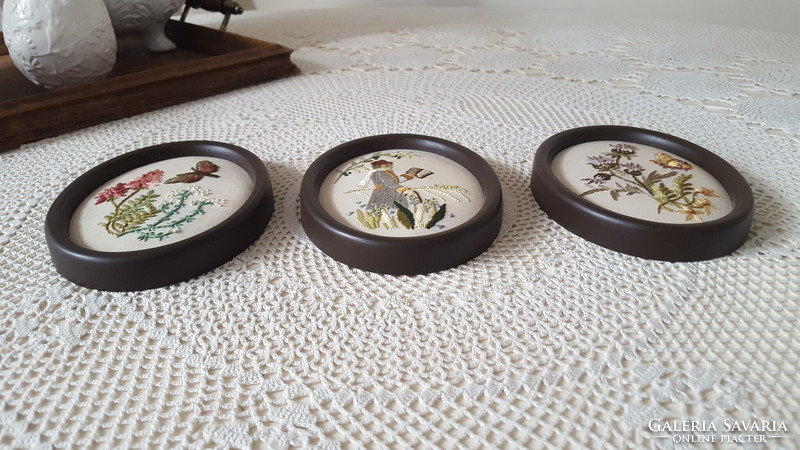 3 hand-sewn, embroidered small oval framed pictures.