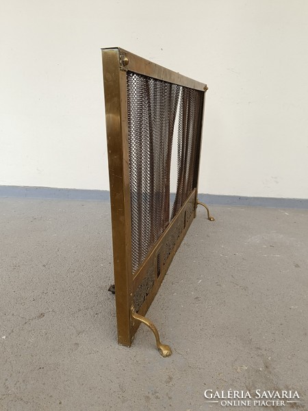 Antique brass stove embers in front of fireplace with retractable braid net 613 8587