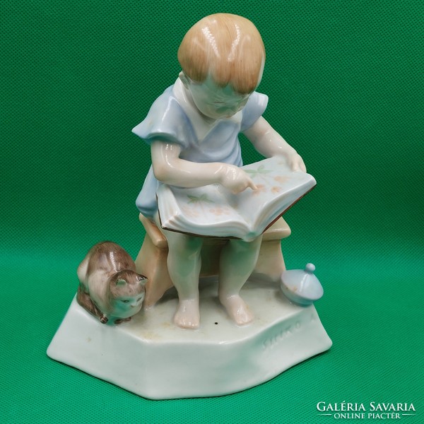 András Zsolnay Sinkó porcelain figurine of a child with a book