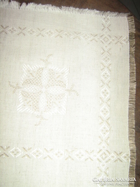 Beautiful elegant beige woven tablecloth with fringed edges