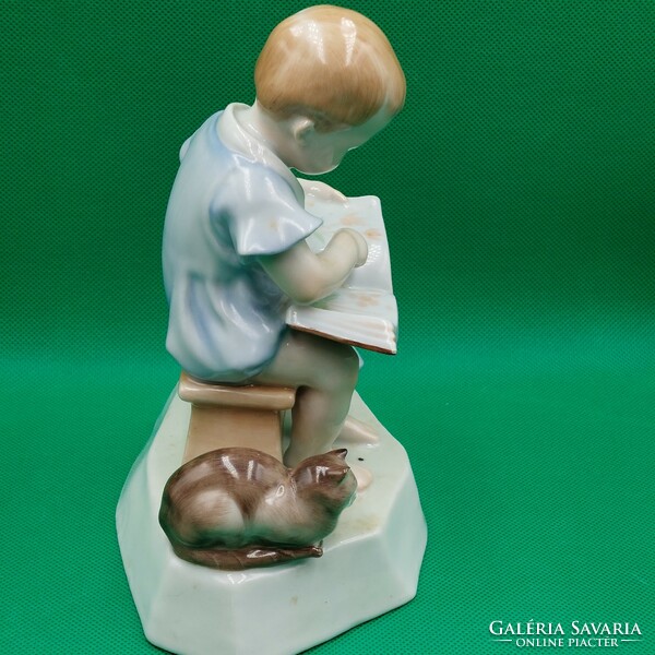 András Zsolnay Sinkó porcelain figurine of a child with a book