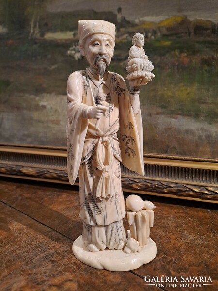 Original Japanese carved bone okimono sage holding Buddha