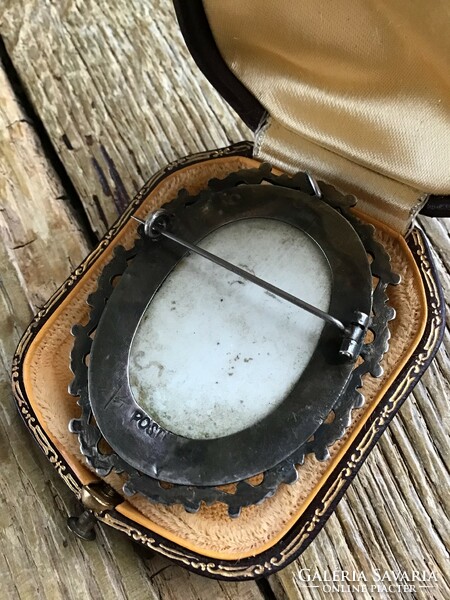 Antique hand-painted porcelain pendant-brooch in a silver frame.