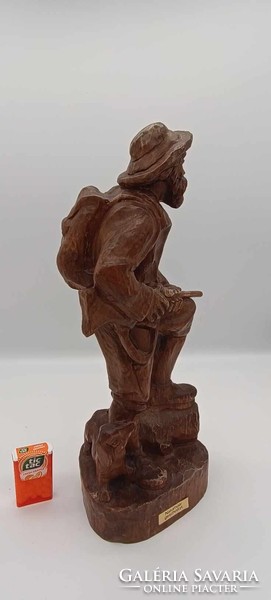 Old hunter wooden statue
