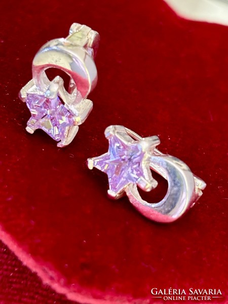 A beautiful pair of silver earrings with a crescent and star motif