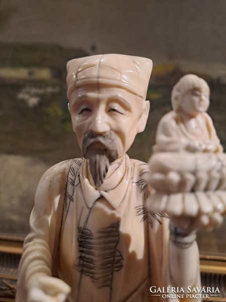 Original Japanese carved bone okimono sage holding Buddha