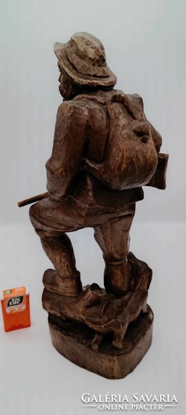 Old hunter wooden statue