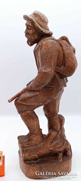 Old hunter wooden statue