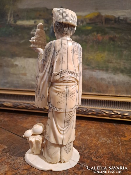 Original Japanese carved bone okimono sage holding Buddha