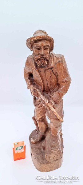 Old hunter wooden statue
