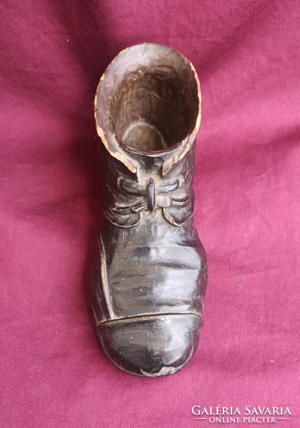 Old, worn shoes. Wood carving. Design window decoration.