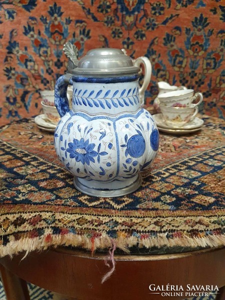 A faience jug marked with a 3-pronged crown coat of arms. 18 cm high. In very nice condition. Is it the end of 19.Sz?