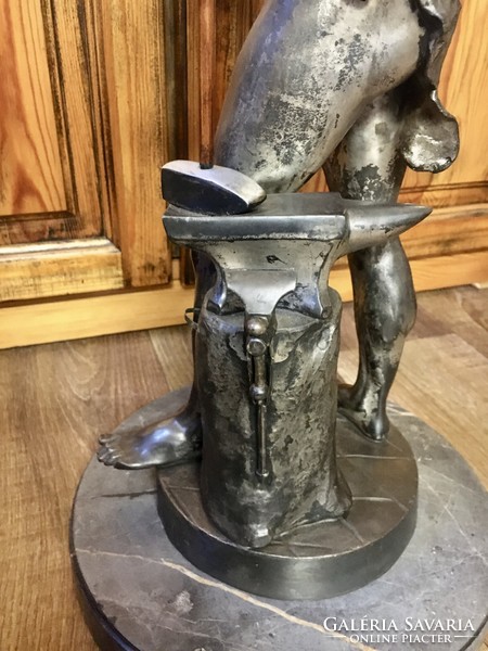 Vintage retro master blacksmith statue on a marble base. 60 cm high