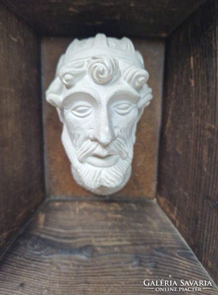 Old plaster head, portrait in a wooden frame